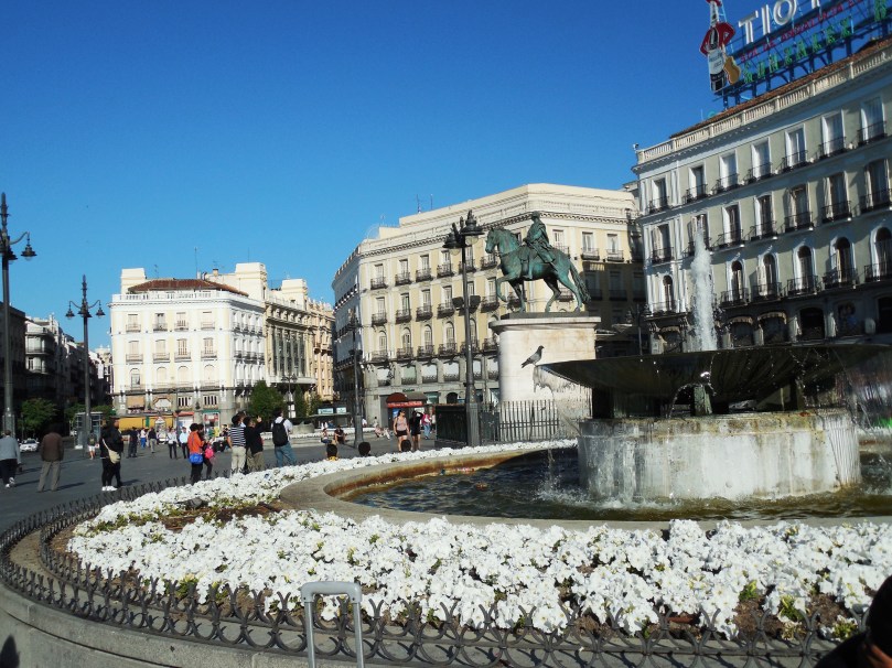 A statue of King Charles III stands in the square near one of the many fountains he had built.