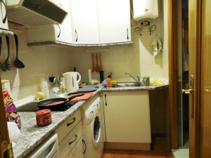 This is our kitchen and laundry room. The bathroom is through the door to the right.