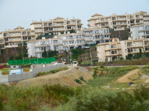 Crowded towns wedged between mountains and coast.