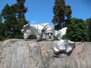 The people who comissioned the monument were expecting a statue of the composer and were a bit upset by what they got. They demanded to have something with his face on it so this plaque was added.