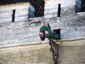 This character is a gutter spout  to drain rainwater out of the palace courtyard - too funny.