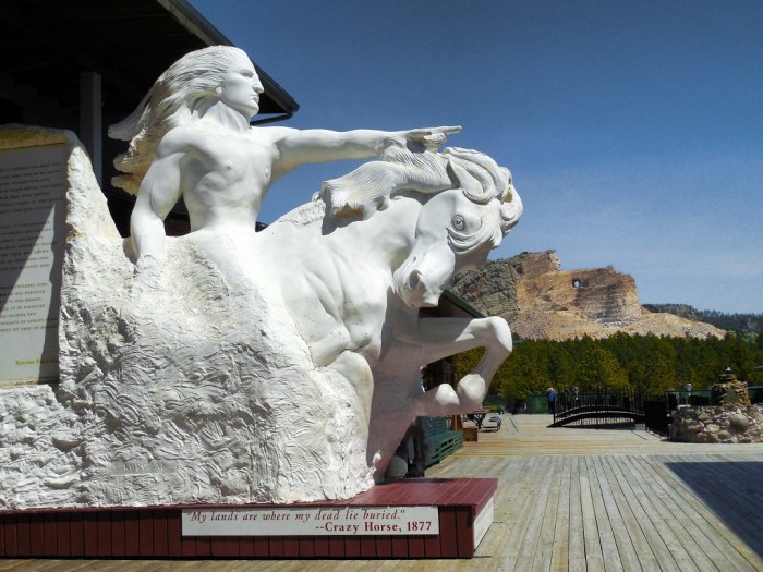 A scale model with the actual sculpture in progress in the background.